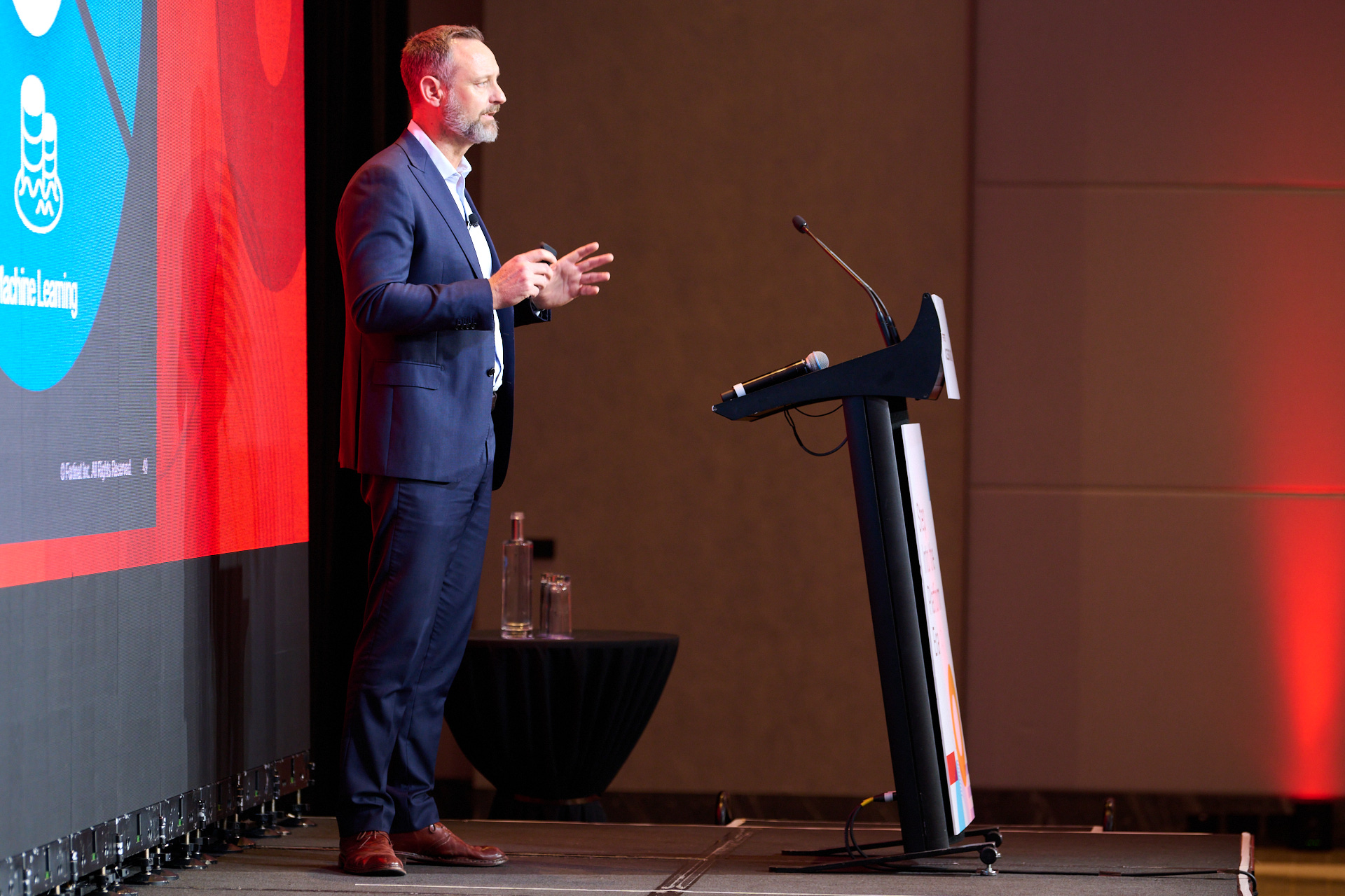 Close up photo of a Speaker on stage at Event in Sofitel Sydney Darling Harbour Close up photo of a Speaker on stage at Event in Sofitel Sydney Darling Harbour