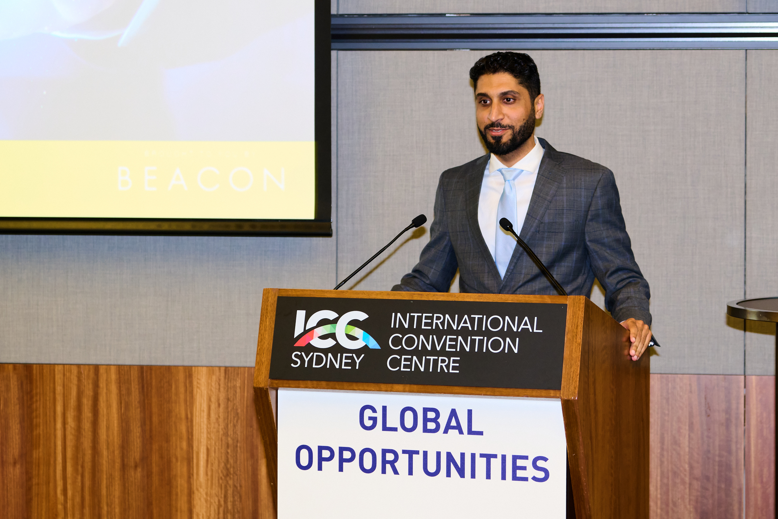 Presenter at a lectern at the ICC Sydney IMARC Event, Global Opportunities